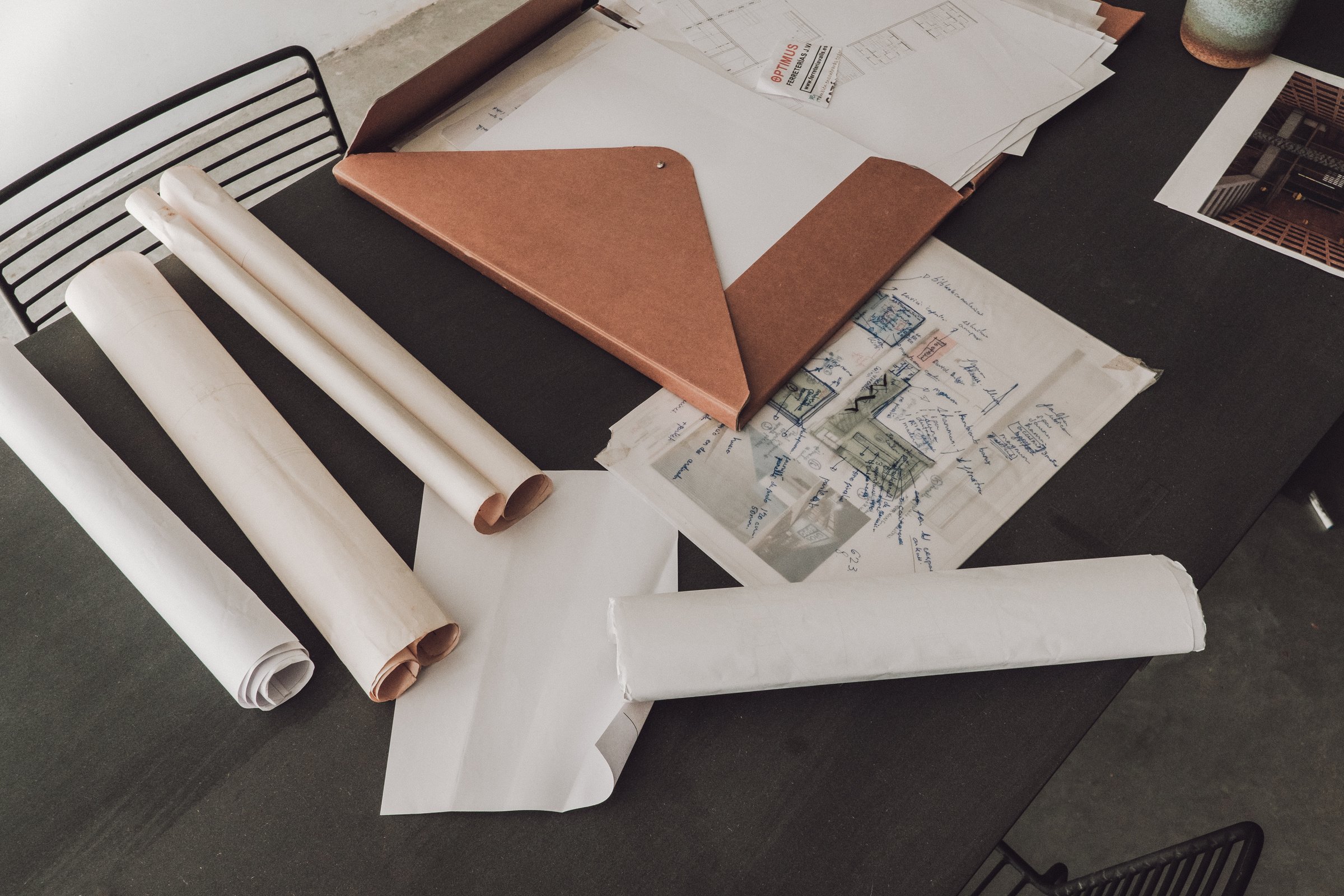 Documents Spread Out on Black Table in Studio